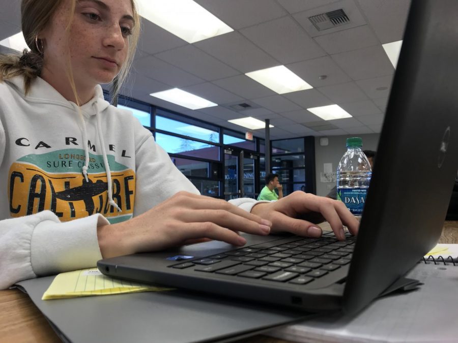 Halli Shea, freshman, works on homework during study hall in the End Zone. Chrome books rolled out campus wide to all students this year.