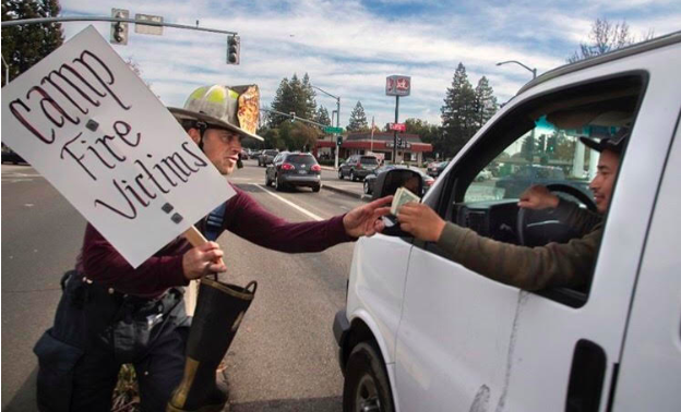 Battalion Chief Brandon Doolan collection a man’s donation during the Fill The Boot Campaign held Dec. 15-16 in Stockton.
